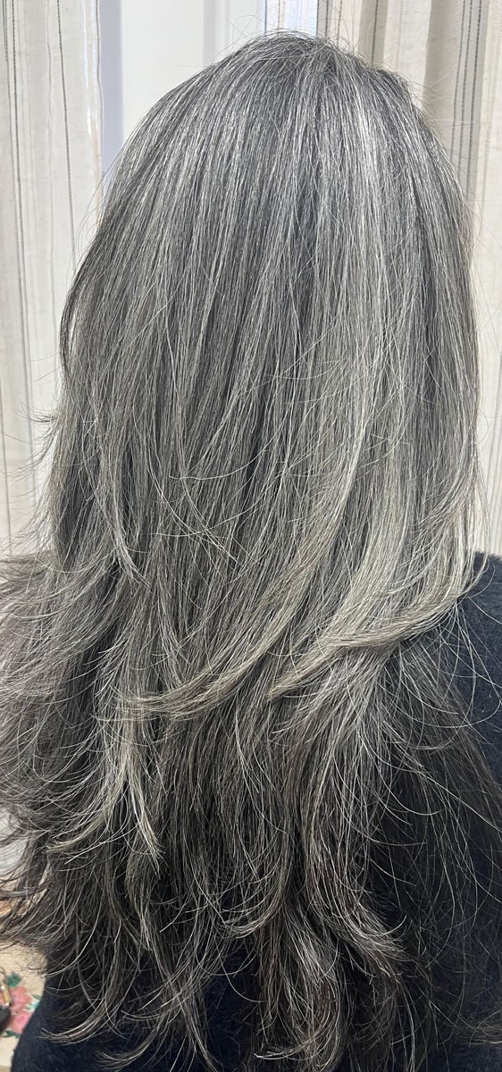 image of woman with long gray hair from the back