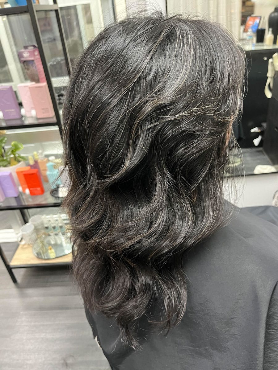 image of salt and pepper long hair woman from the side